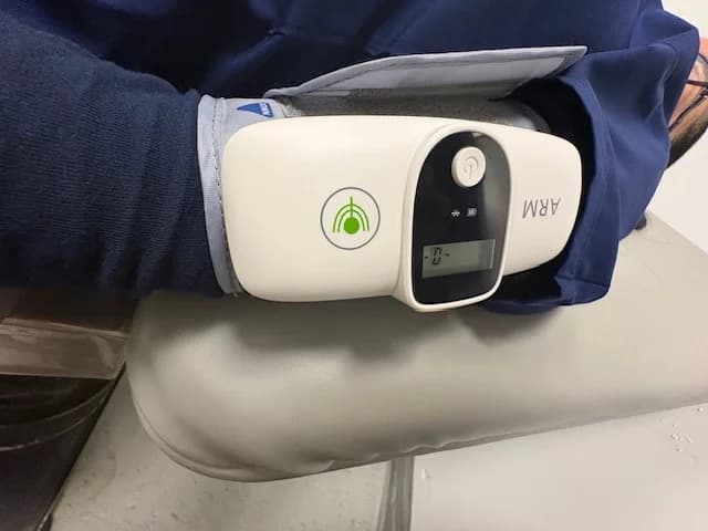 The C-MAT arm cuff device being used on a patient's arm